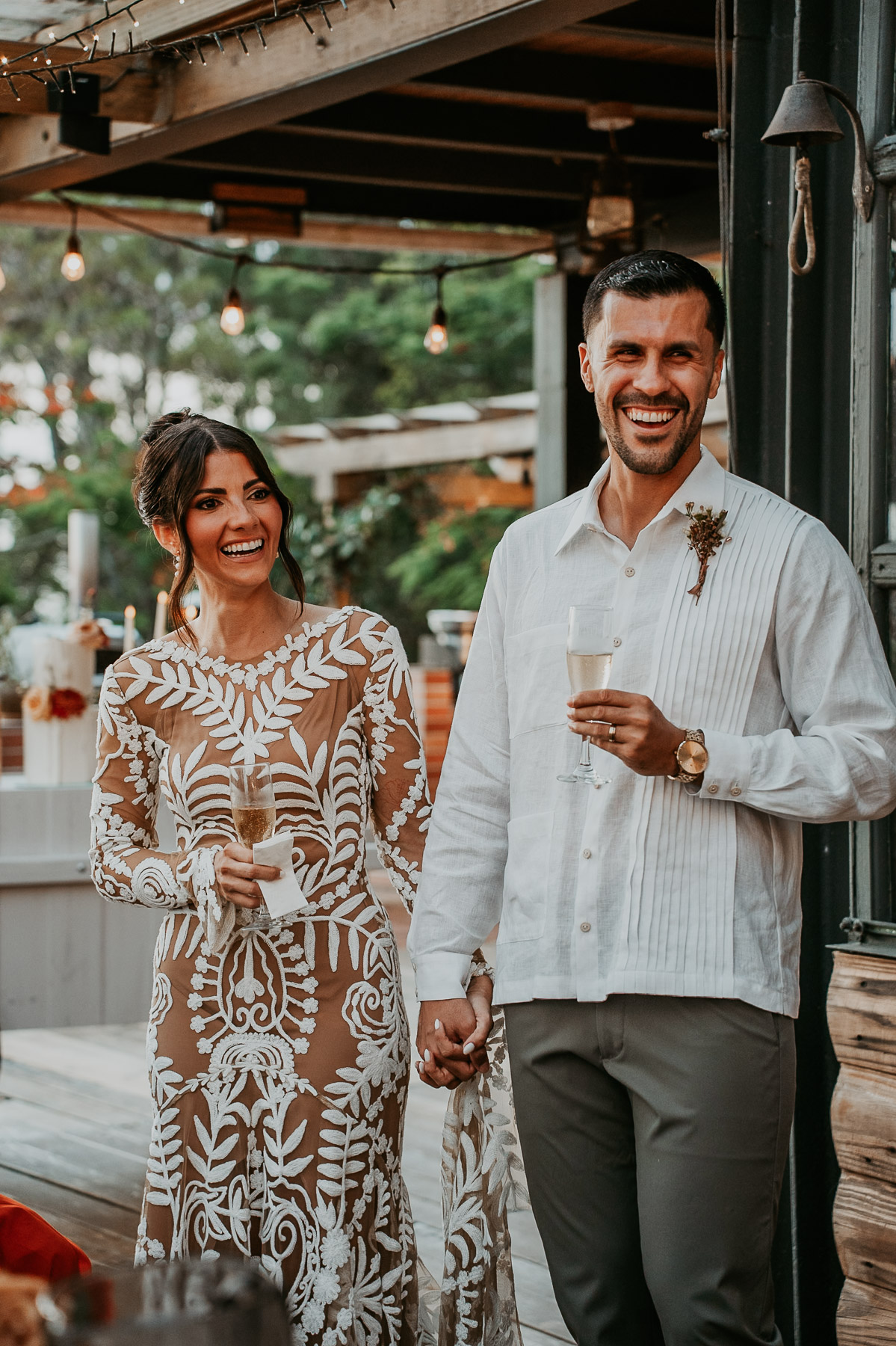 Newlyweds laughing and cheering with champagne in El Pretexto Puerto Rico