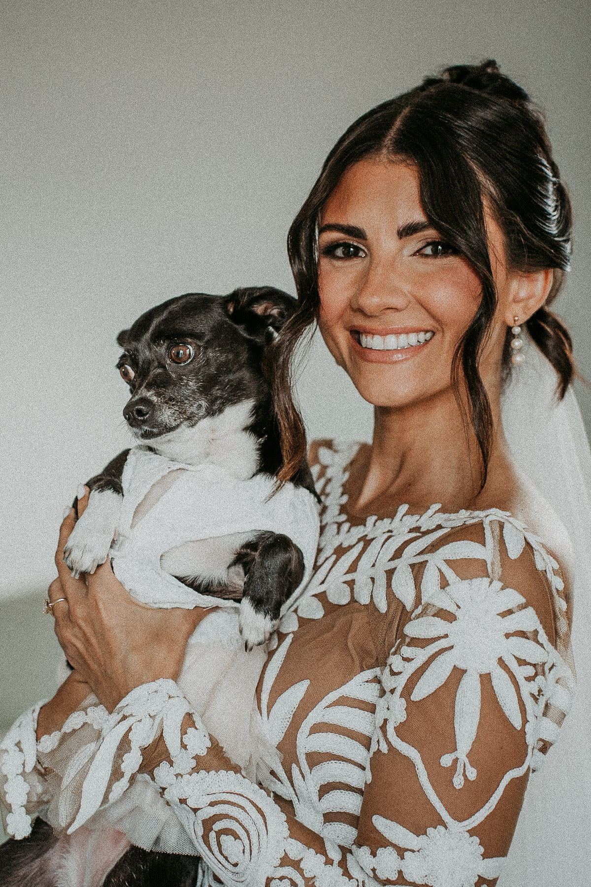 Bride posing with dog during getting ready before her wedding at El Pretexto Puerto Rico