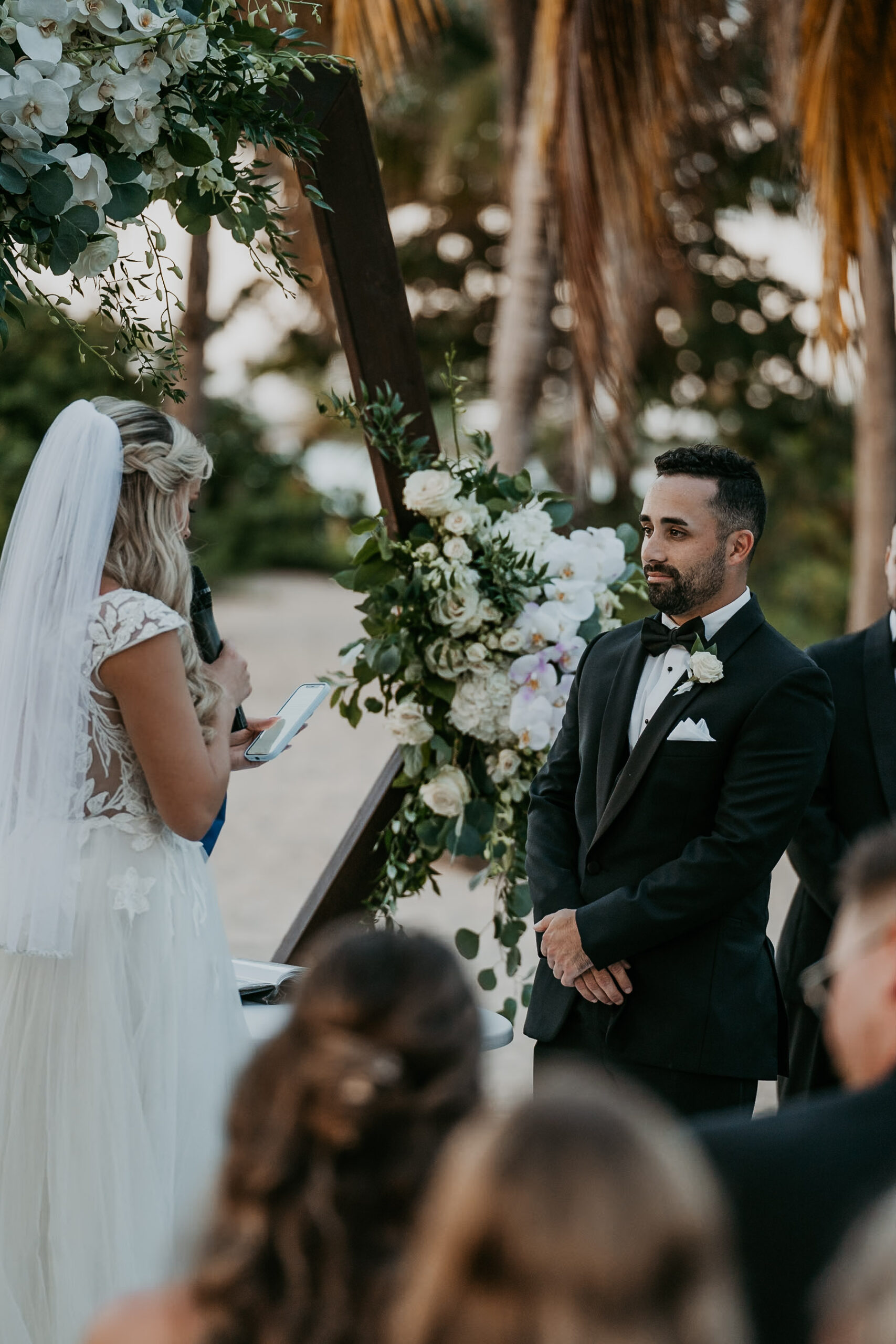 Bride and groom exchanging vows with the ocean as a backdrop at Courtyard Marriott