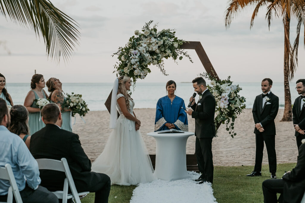 Bride and groom exchanging vows with the ocean as a backdrop at Courtyard Marriott