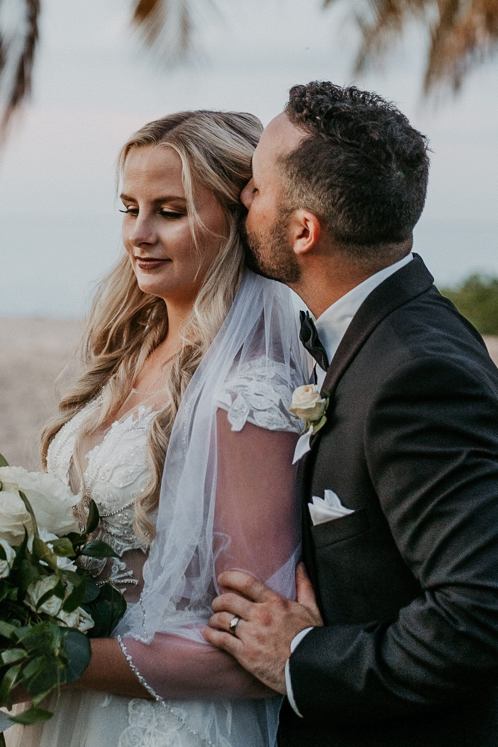 Groom kissing bride at COurtyard Marriot Isla Verde