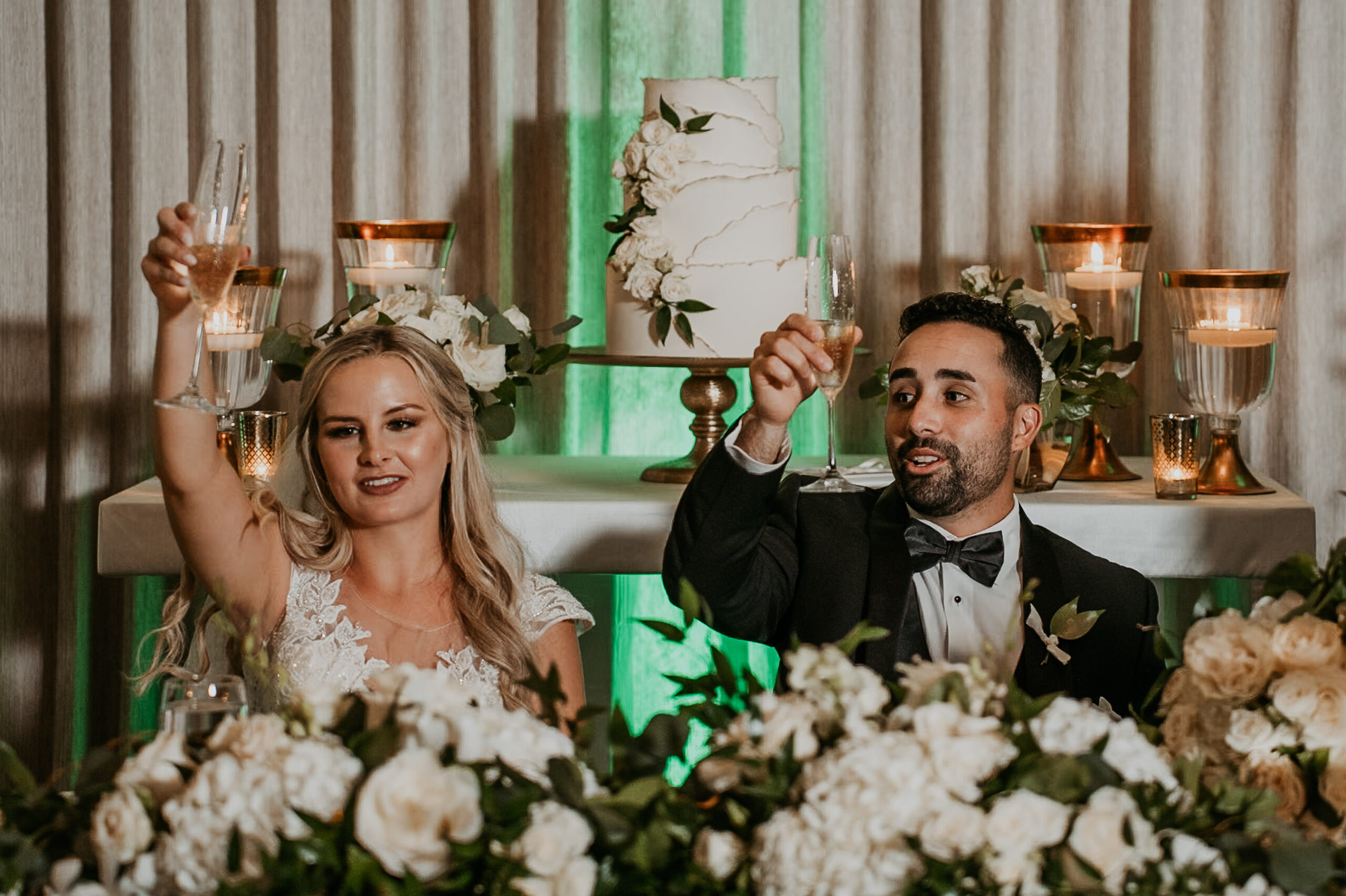 Bride and groom raising champagne glasses during wedding toast at Courtyard Marriott Puerto Rico