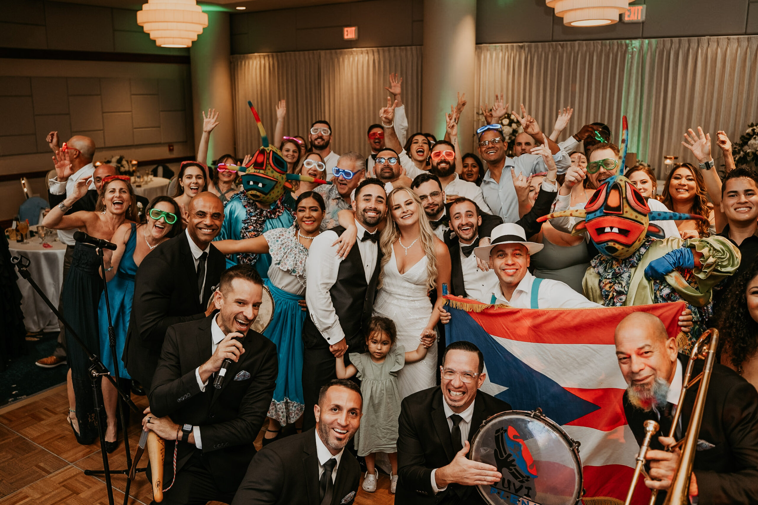 Wedding guests and couple celebrating with Pleneros drummers at Salon del Mar reception in Puerto Rico