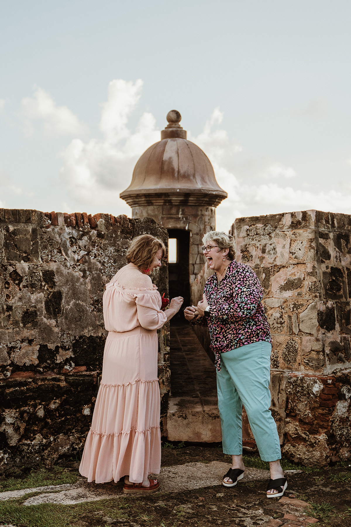 Lesbian couple proposal near Castillo San Cristóbal in Old San Juan Puerto Rico, LGBTQ love story with historic backdrop and inclusive wedding photography