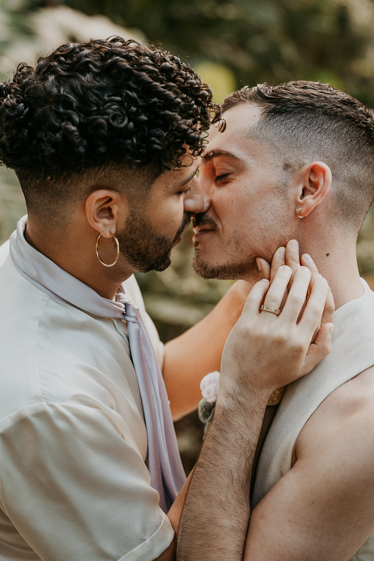 Outdoor wedding portraits capturing authentic moments between an LGBTQ couple in a tropical venue