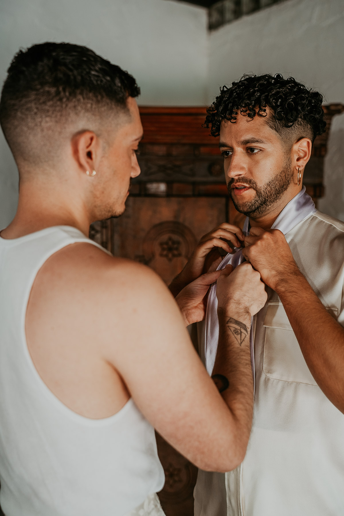 LGBTQ couple preparing for their wedding day in Puerto Rico with natural light and relaxed vibes.