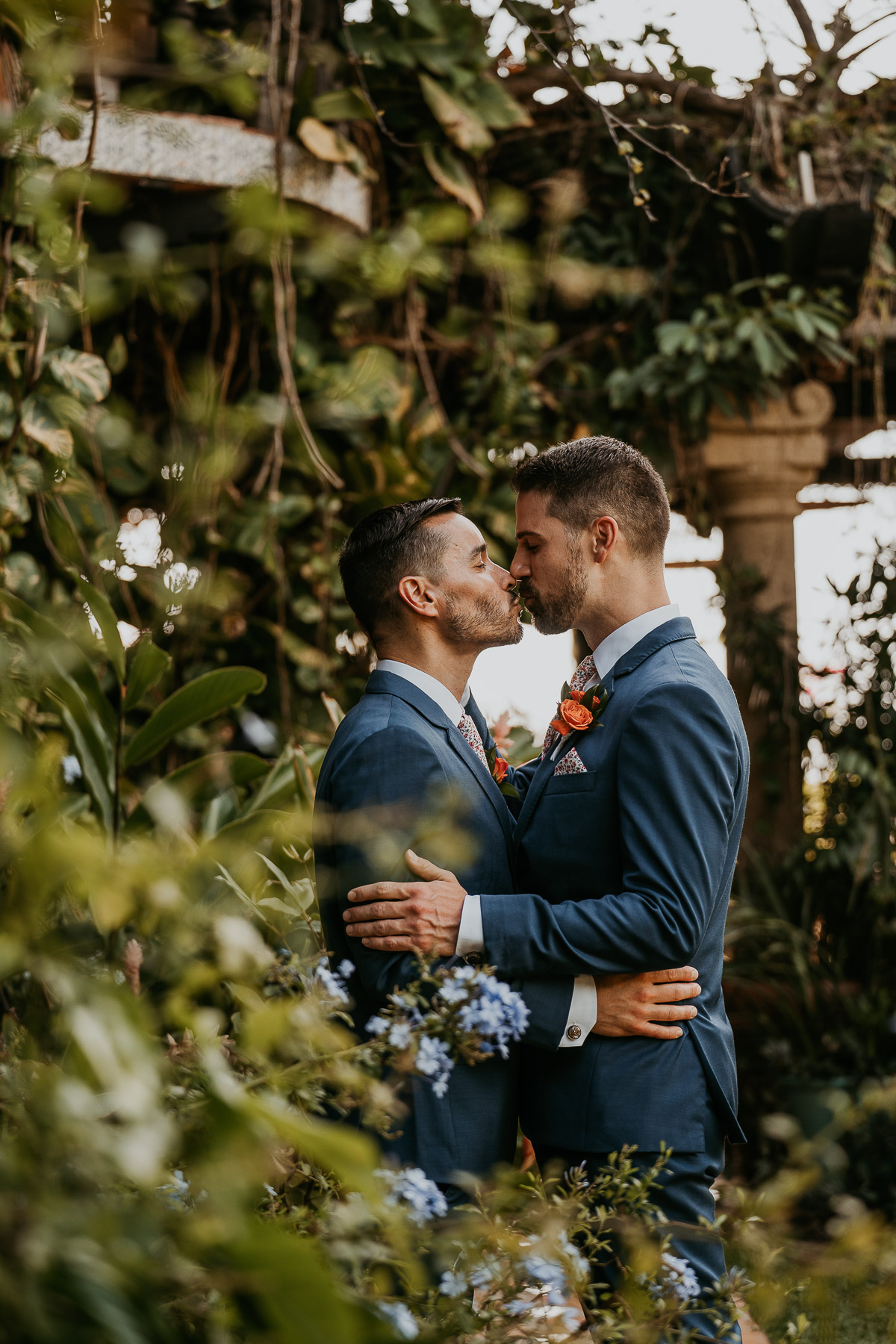 Romantic LGBTQ+ couple's wedding at Hacienda Siesta Alegre with lush tropical gardens and El Yunque in the background