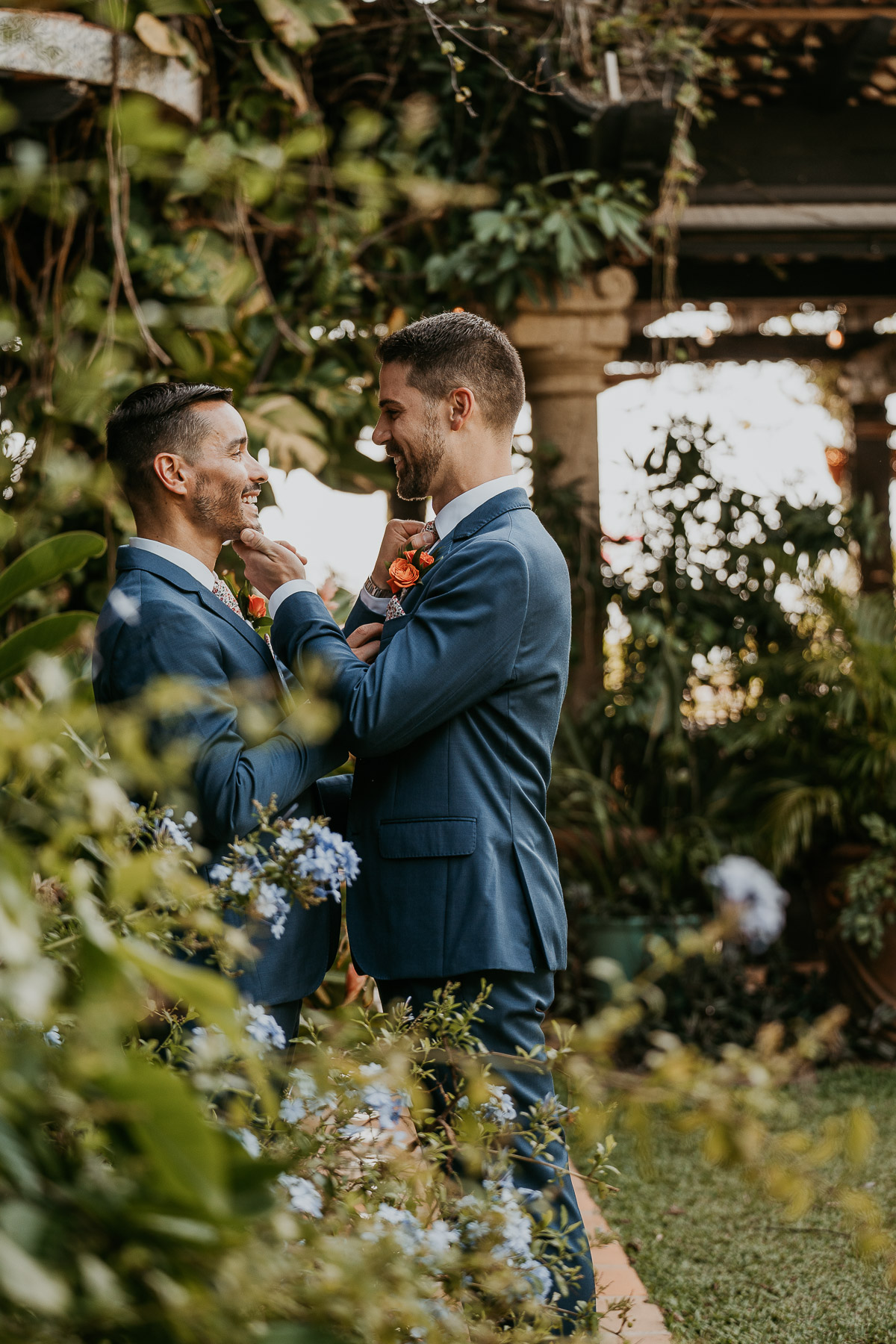 Romantic LGBTQ+ couple's wedding at Hacienda Siesta Alegre with lush tropical gardens and El Yunque in the background