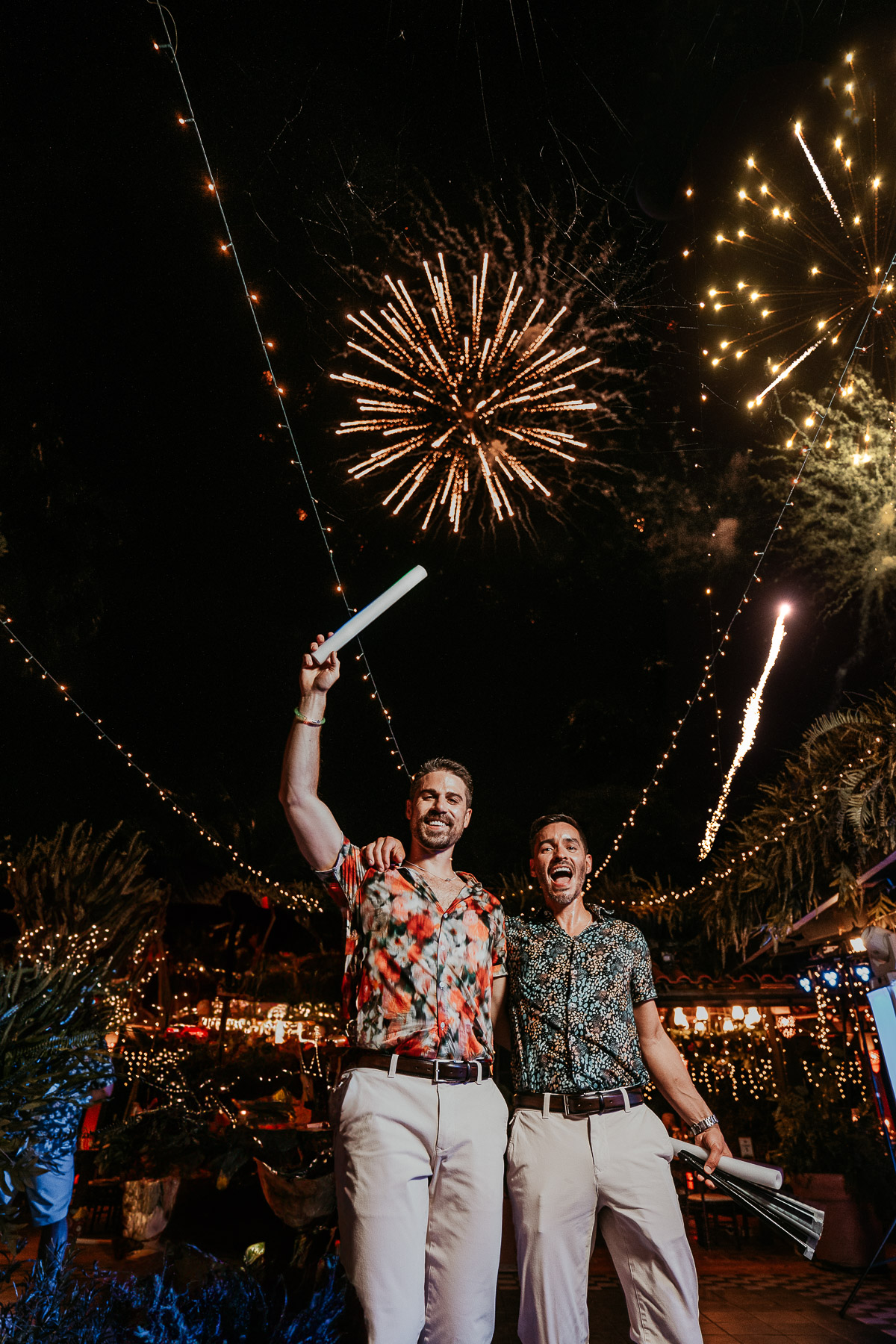 Two grooms enjoy fireworks during Hacienda Siesta Alegre LGBTQ+ wedding