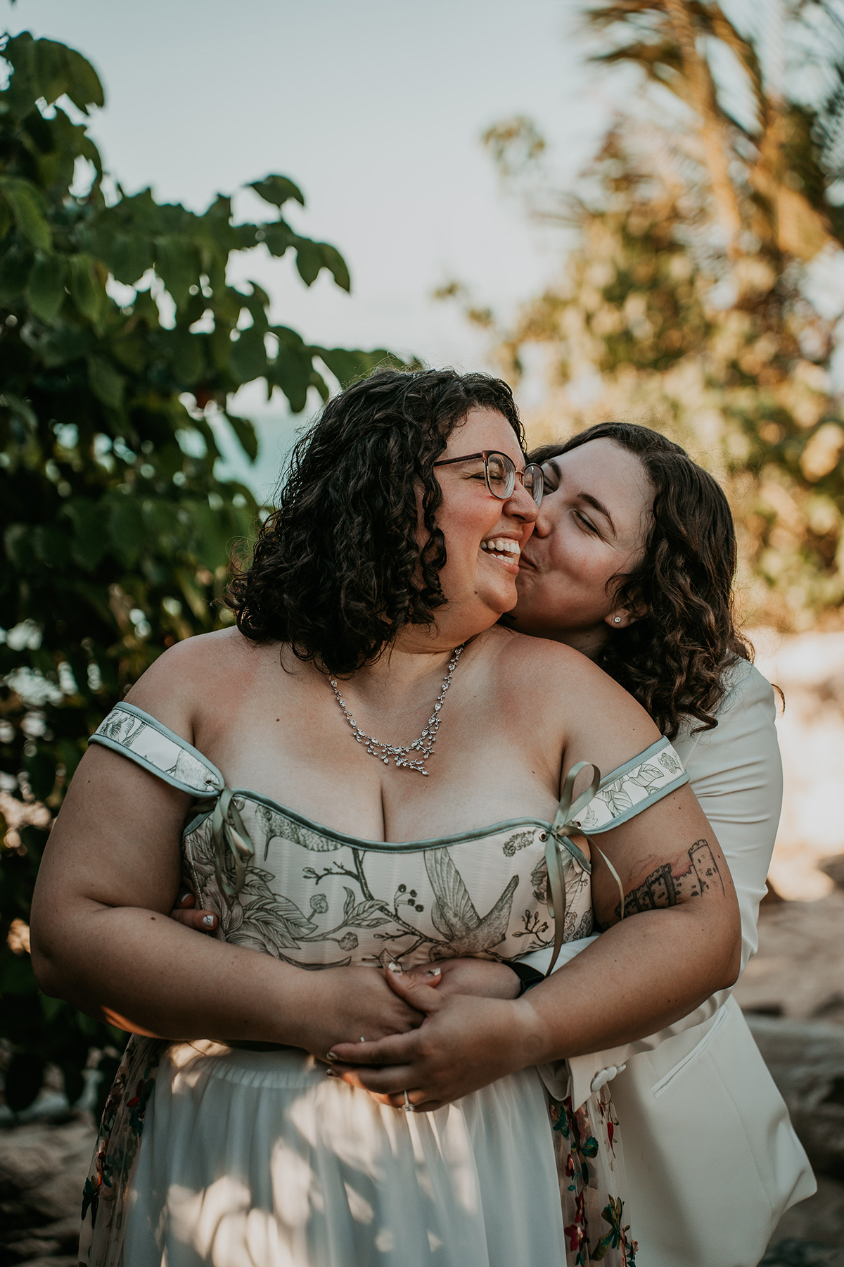 Lesbian couple embracing after wedding ceremony