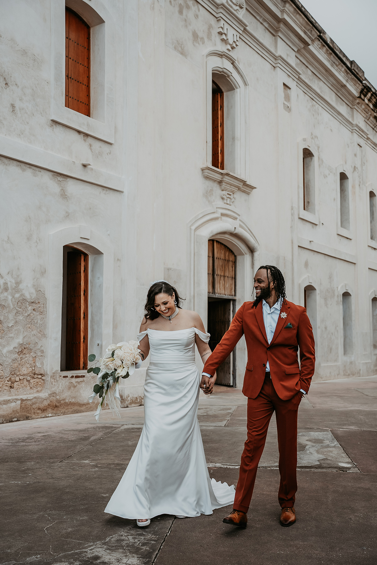 Interracial couple in wedding attire in Old San Juan