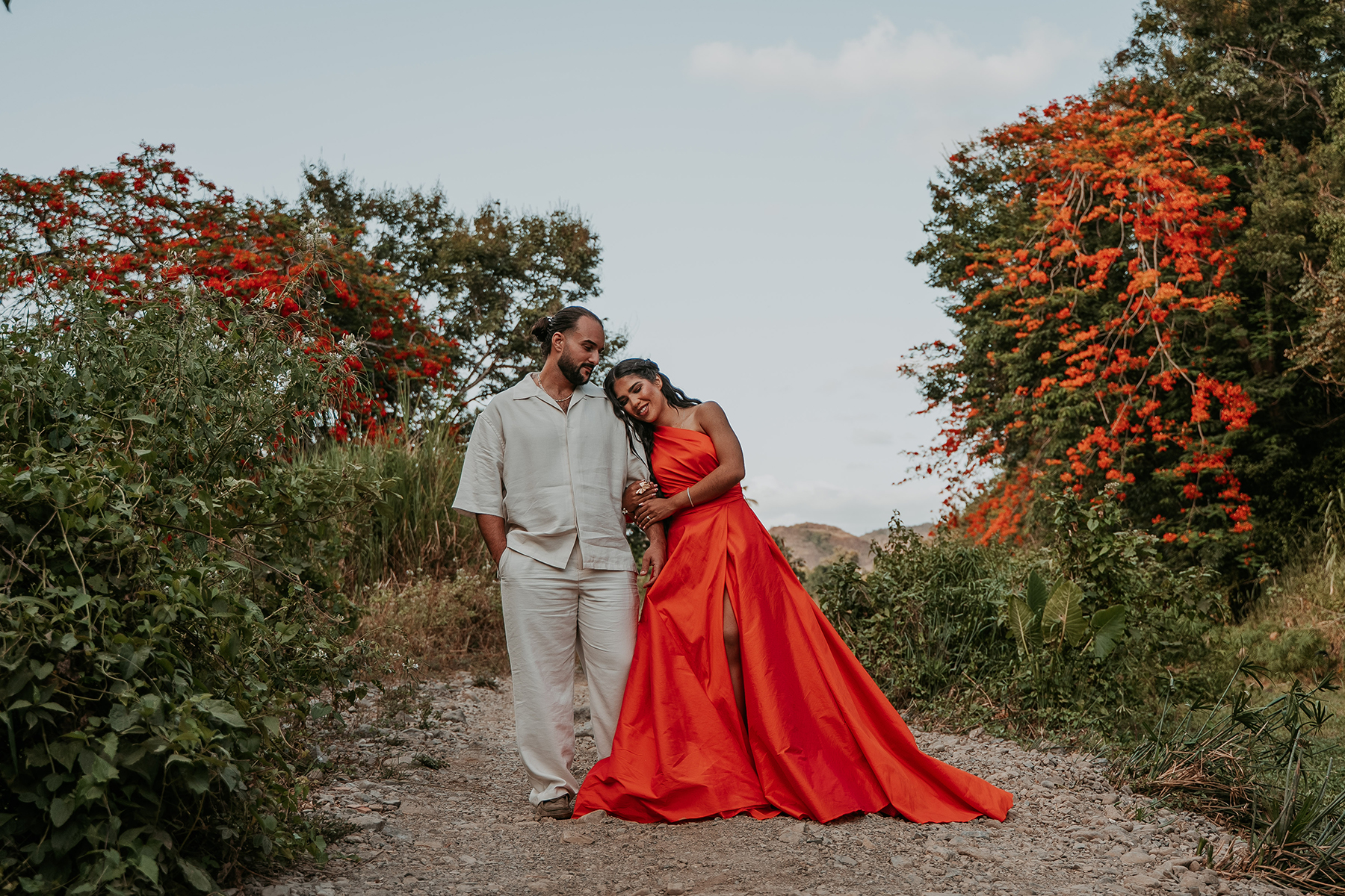 Couple enjoying an outdoor engagement photo session in Puerto Rico surrounded by tropical greenery
