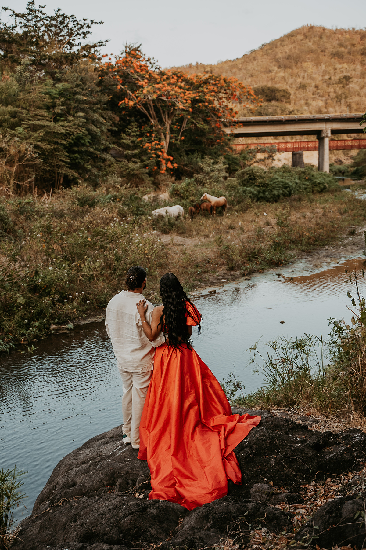 Couple posing together in a lush Puerto Rico river landscape during an outdoor engagement photo session