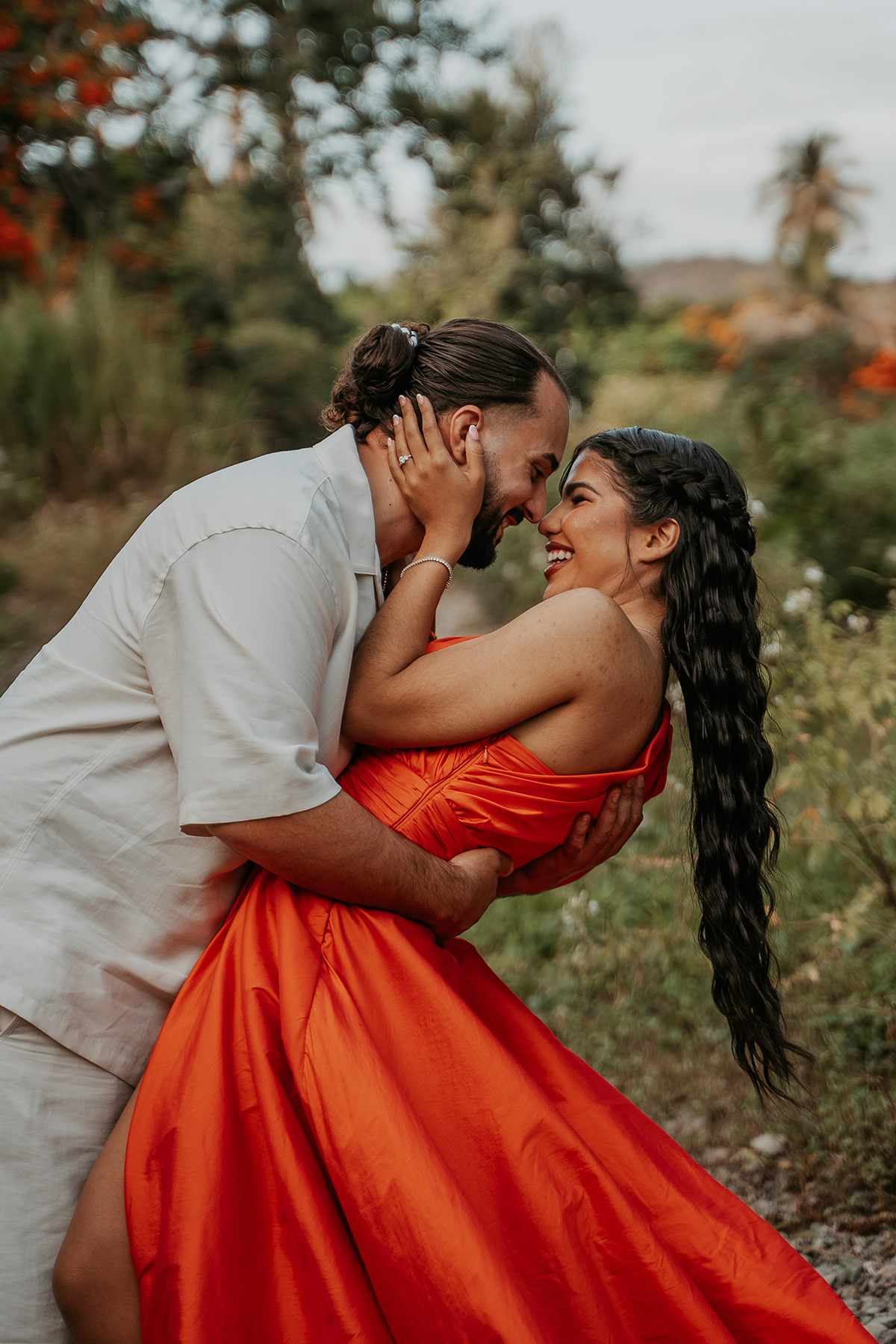 Candid portrait of couple laughing and embracing beside a river during their Puerto Rico outdoor photo session