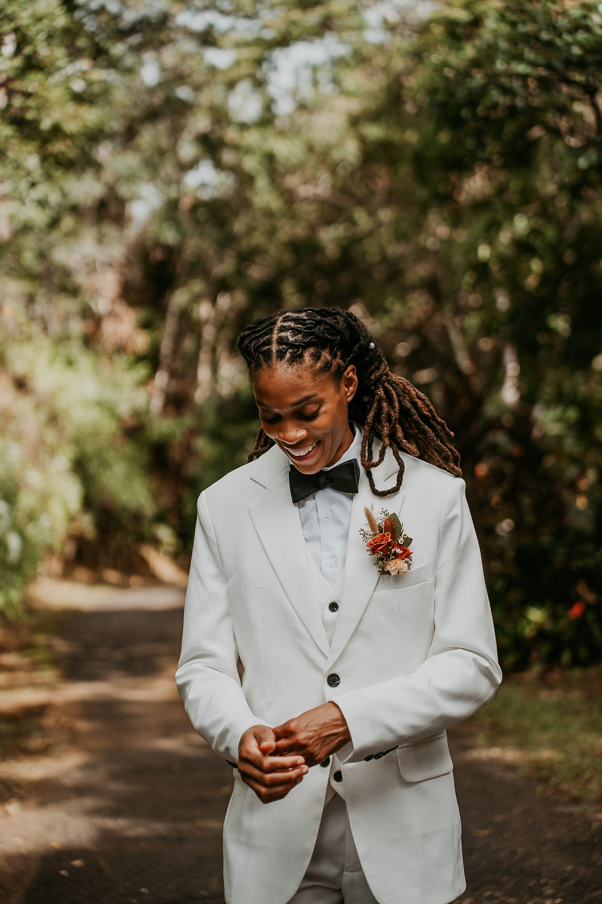 Bride wearing white suit poses for her pictures during her Puerto Rico Micro Wedding.