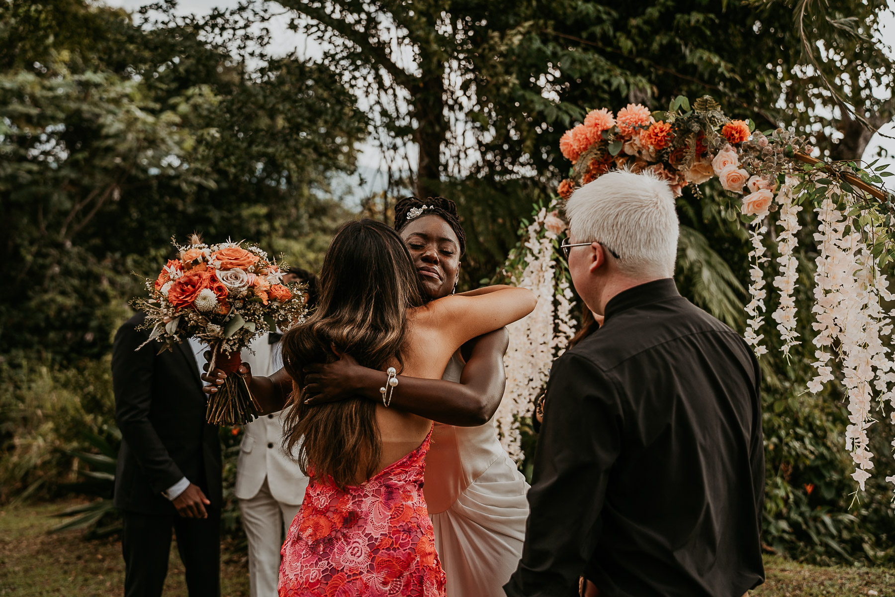 Bride embraces sibling during a micro wedding at an Airbnb in Puerto Rico.