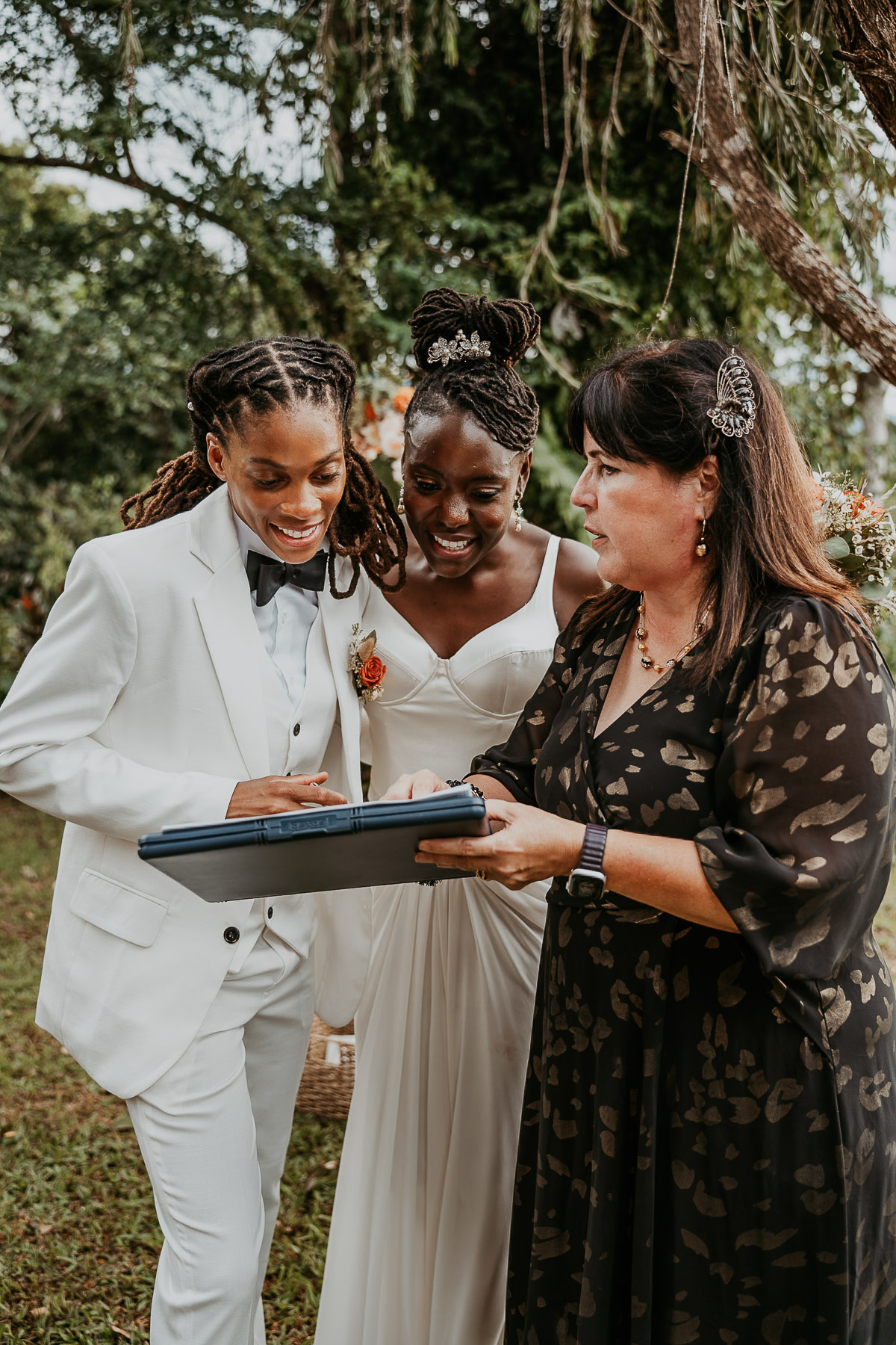 Brides sign marriage certificate during their micro wedding at an Airbnb in Puerto Rico.