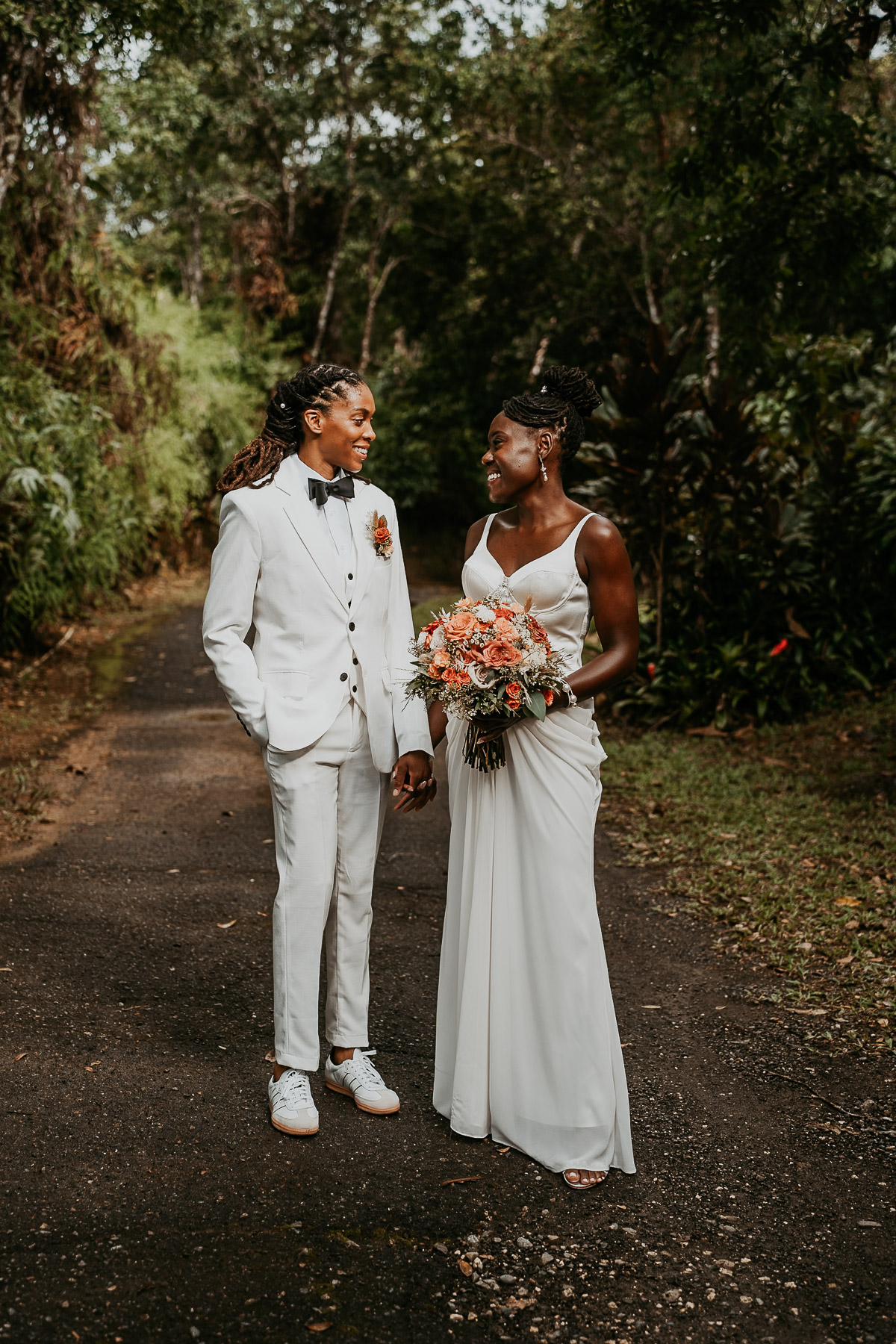 An elegant portrait of the brides against the stunning natural surroundings of their Airbnb venue.