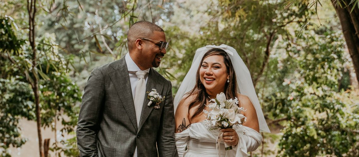 Bride and groom walking happily after saying I do at Dos Aguas Elopement.