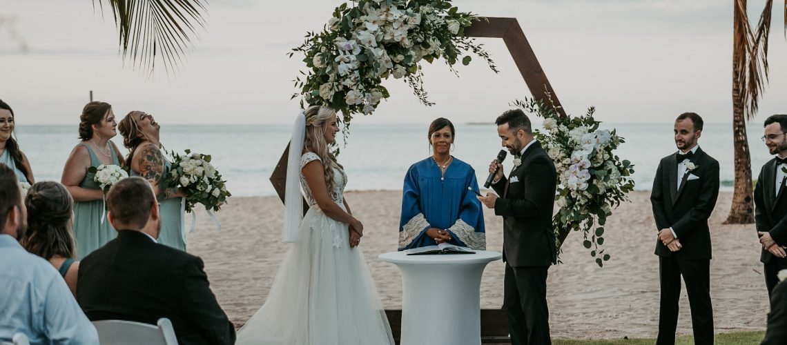 Bride and groom exchanging vows with the ocean as a backdrop at Courtyard Marriott