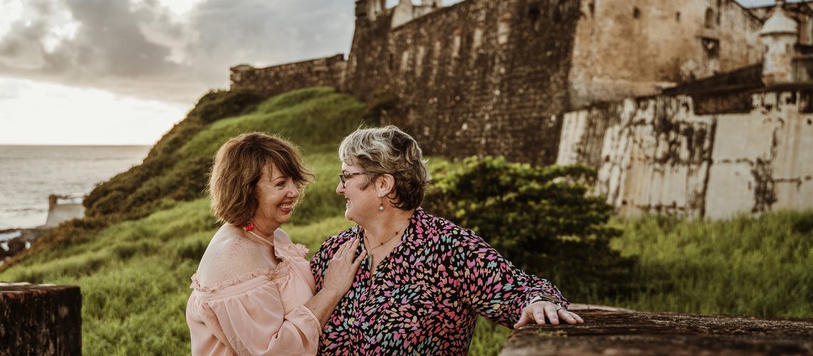 Lesbian couple proposal near Castillo San Cristóbal in Old San Juan Puerto Rico, LGBTQ love story with historic backdrop and inclusive wedding photography